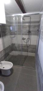 a bathroom with a shower and a toilet at Apartmani Dada Kanjon Grmuša in Bihać +88 photos