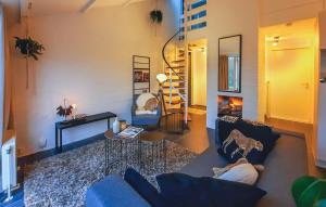 a living room with a blue couch and a fireplace at Vakantiehuis Heinkenszand met omheinde tuin & hondvriendelijk VP046 in Heinkensand