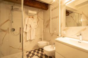 a bathroom with a shower and a toilet and a sink at Castello di Porcìa - Residence Agrituristico in Porcia +52 photos