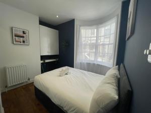 a bedroom with a white bed and a window at First Avenue Apartments in Moffat