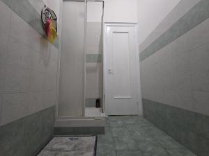 a bathroom with a walk in shower and a door at Room PR Casa Solari in Genova