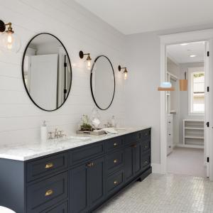 a bathroom with a black vanity and a mirror at Ataas Apartment Homes Islamabad in Dargai