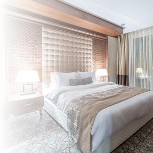 a bedroom with a large bed with a large headboard at Ataas Apartment Homes Islamabad in Dargai