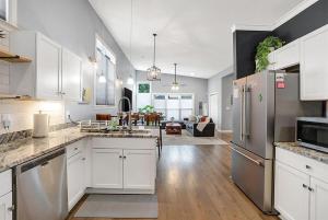 a kitchen with white cabinets and stainless steel appliances at Close to everything downtown in Indianapolis