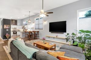 a living room with a couch and a flat screen tv at Close to everything downtown in Indianapolis