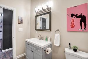 a bathroom with a sink and a mirror and a toilet at Close to everything downtown in Indianapolis +45 photos