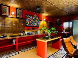 a kitchen with red walls and a red counter top at Casa Manalo Guest House in Puerto Princesa City