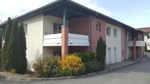 a house with a balcony on the side of it at Cite Espace Apartment in Toulouse