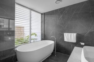 a bathroom with a white bath tub and a sink at Mount View Estate Two Bedroom Country Stay The Semillon U1 in Mount View