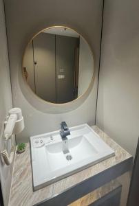 a bathroom with a sink and a mirror at Extreme Boutique Hotel in Kluang