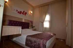 Postel nebo postele na pokoji v ubytování Hotel Konak Su