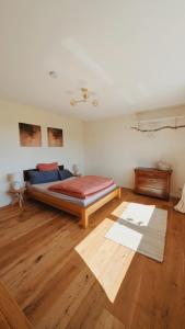 a bedroom with a bed and a wooden floor at Ruhige Wohnung mit Ausblick in Extertal