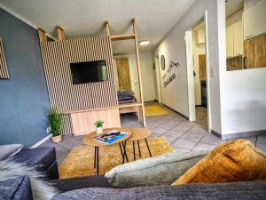 a living room with a couch and a table at Apart Weisshorn WHG 122 Valère B in Leukerbad