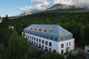 a building with a solar roof on top of it at TRITA SK - Lebenski A27 - Infrasauna - Brand new - Parking in Vysoké Tatry +10 photos