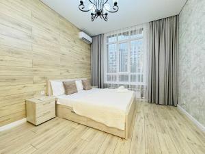 Ένα ή περισσότερα κρεβάτια σε δωμάτιο στο Almatym 22 Apartment