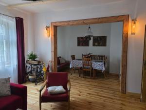 a living room with a door open to a dining room at Gasthaus Rokitnik in Rokity