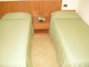 two beds sitting next to each other in a bedroom at La Collinetta in Montazzoli
