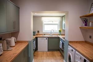 a kitchen with a sink and a dishwasher at Large House Near Racecourse, City & Uni in Henwick
