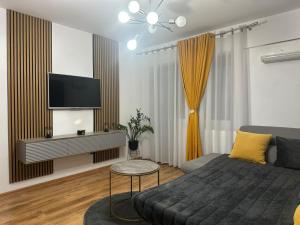a living room with a couch and a flat screen tv at Studio Mamaia Nord in Mamaia Nord +19 photos