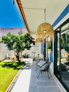a patio with a chandelier hanging from the ceiling at Trendy one bedroom house, beach & lagoon in Foz do Arelho +10 photos