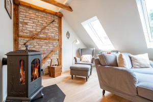 a living room with a fireplace and a couch at Altes Tagelöhner Haus - Whg 1 in Pudagla