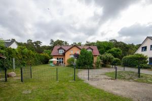 a fence in front of a house at Ferienhaus Paul in Trassenheide