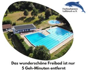 an aerial view of a swimming pool with a building at Ruhige Wohnung mit Ausblick in Extertal