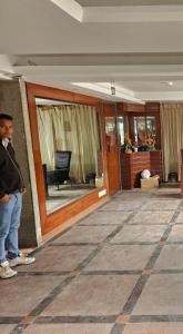 a man standing in front of a building at Hotel Krishna Land in New Delhi