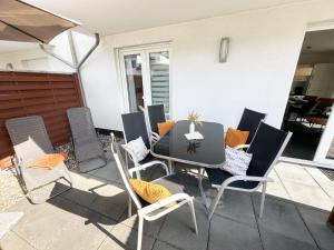 a patio with a table and chairs on a patio at Haus Sanddorn - Whg 4 in Thiessow