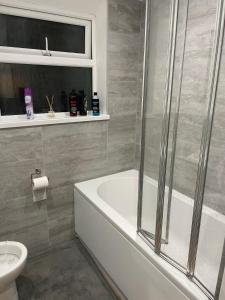 a bathroom with a shower and a tub and a toilet at Room in Cardiff City near Hospital in Cardiff