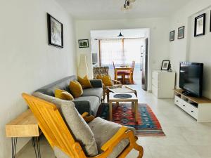 a living room with a couch and a tv at Katya's home in Datca