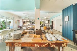 a dining room with a table with dishes on it at Hotel Austral by Exsel in Saint-Denis