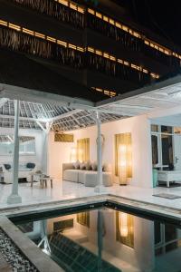 a villa with a swimming pool at night at Modern 3BR Villa, 4min to Double Six Beach, Pool in Seminyak