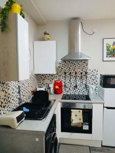 a kitchen with a stove and a stove top oven at 43 Digbeth Private Studio Apart in Birmingham +4 photos