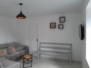 a living room with a couch and a chair at Gîte de l'Aubrigoux - Maison in Saint-Jean-dʼAubrigoux