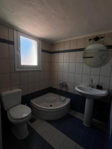 a bathroom with a toilet and a sink at Aegean Breeze in Lilikás
