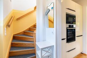 a hallway with stairs in a house at Ferienhaus Knospe in Ueckeritz +4 photos
