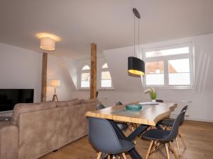 a living room with a couch and a wooden table at Traum-Ferienwohnung Mozart ! in Wilhelmshaven
