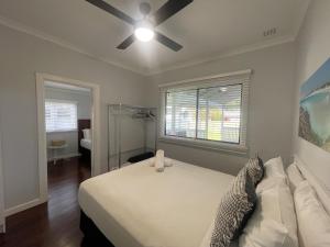 a bedroom with a bed and a ceiling fan at Dempster House in Esperance