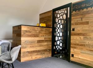 a room with a wooden wall and a door at Willa przy Krupówkach in Zakopane