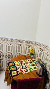 a room with a table with a birthday blanket on it at Heritage House in Nizwa