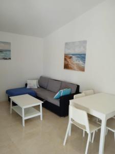 a living room with a couch and a table at Apartments Zlata in Lopar