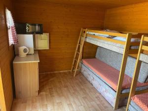 a room with two bunk beds in a cabin at Autocamp Free Star - Chatky a Bungalovy in Strachotín +28 photos