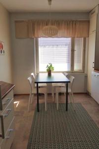a dining room table with a potted plant on it at Apartment Vanhatie, 3mh in Pyhäjoki