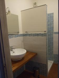 a bathroom with a sink and a mirror and a shower at Costa Azzurra in Giardini Naxos