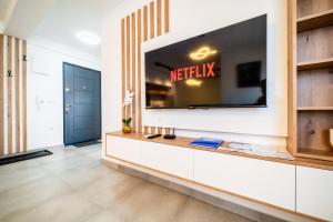 a living room with a television on a wall at Todorović Lux Vrnjačka Banja in Vrnjačka Banja