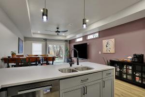 a kitchen with a sink and a dining room at Walk to Bars and Restaurants in Fountain Square in Indianapolis