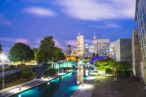 a city at night with a river and buildings at Walk to Bars and Restaurants in Fountain Square in Indianapolis