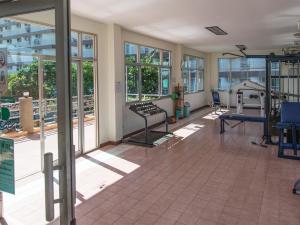 a gym with treadmills and machines in a building at Jomtien Beach Condominium S1 by Olga in Jomtien Beach