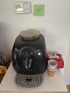 a black toaster sitting on top of a counter at LUMON Ultra Central Apartman in Târgu-Mureş